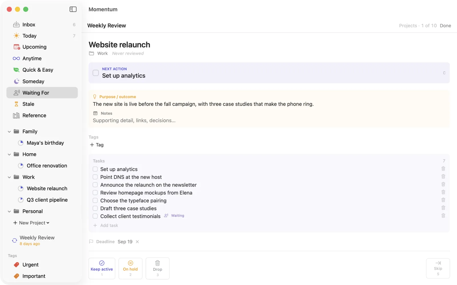 The Weekly Review card for one project: its next action, purpose, open tasks and deadline, with Keep active, On hold and Drop buttons.